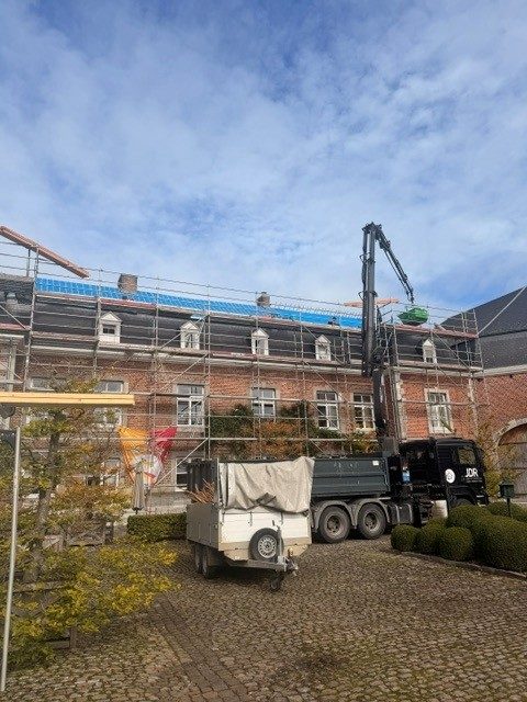Réfection de toiture du château, camion-grue et échafaudage le long de la façade en brique